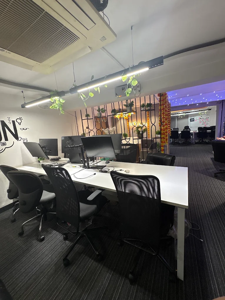 Meeting room with a long white table and ergonomic chairs
