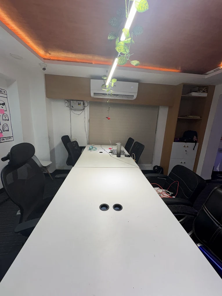 Main floor of the Workstation coworking space with white desks and black chairs